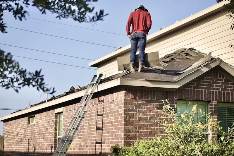 Professional roofer working on a residential roof in Bonair
